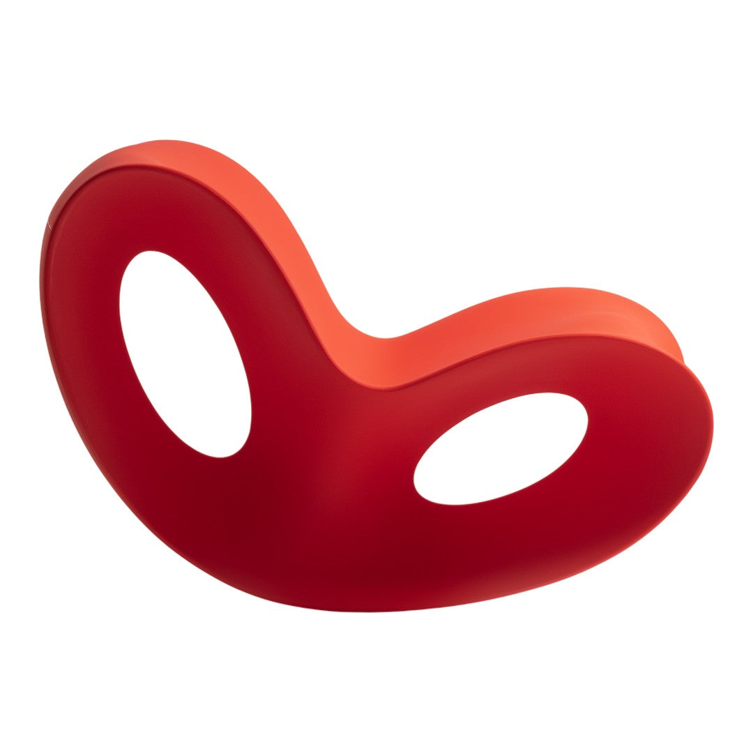 Vibrant red ergonomic chair with smooth curves and cut-out holes for a modern, playful design.