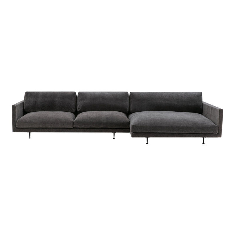 Modern gray sectional sofa with a sleek design and soft velvet fabric, featuring minimalistic lines and subtle textures.