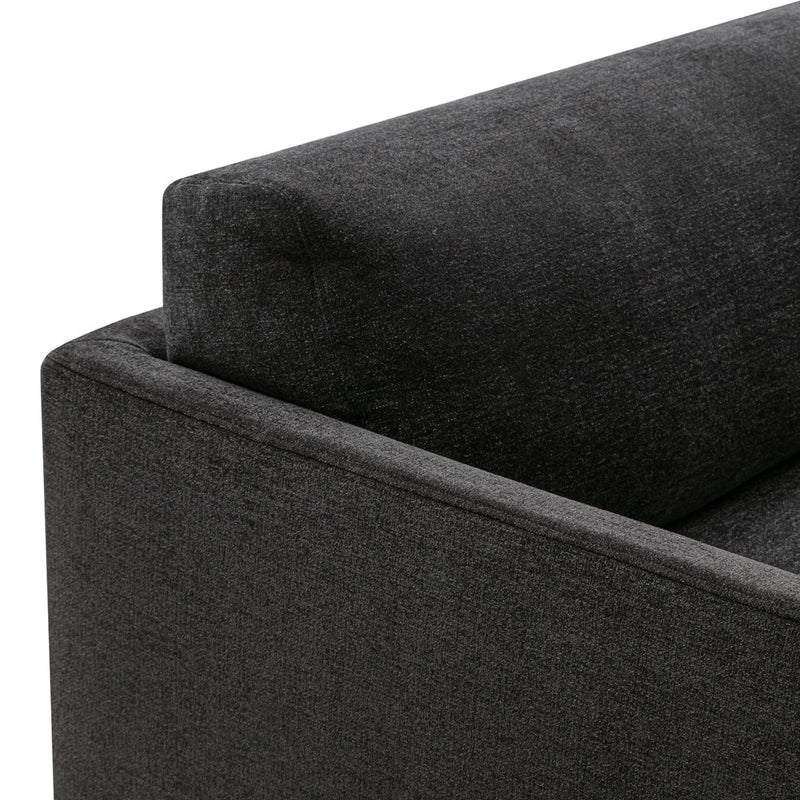 Dark gray fabric sofa corner with clean lines and a subtle texture, perfect for modern interior designs.
