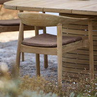 Natural wood chair with a light finish and a dark brown seat cushion, featuring a simple, modern design.