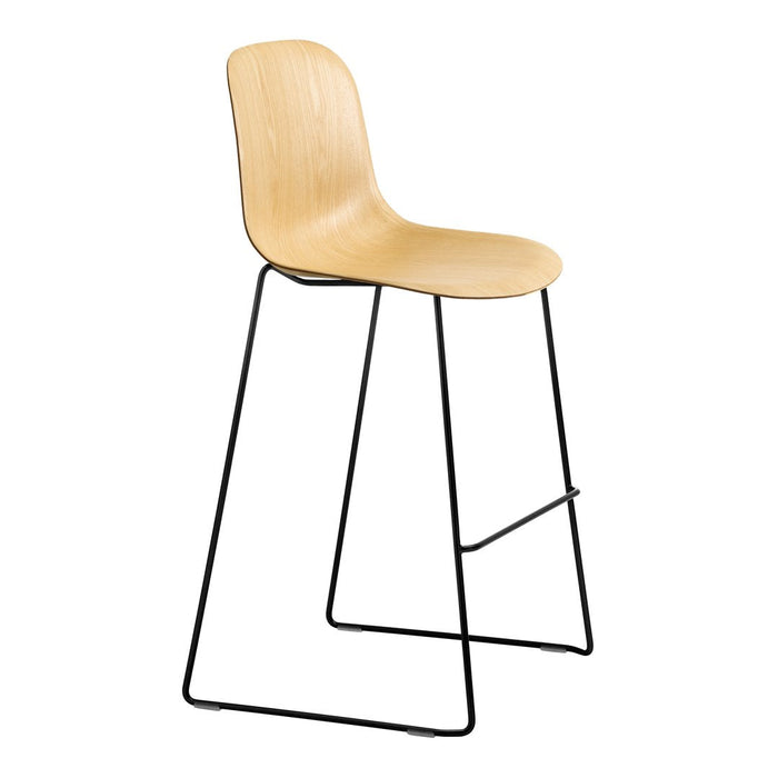 Natural wood-colored chair with smooth curves and black metal legs, minimalist design, modern aesthetic.