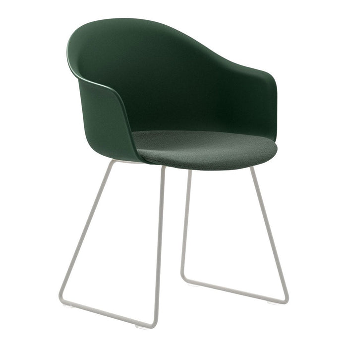 Dark green curved chair with a sleek design and light metal legs, perfect for modern decor.