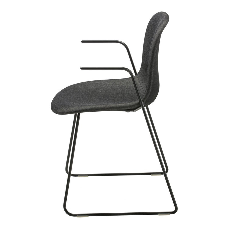 Side view of a sleek, modern chair in dark gray upholstery with a minimalist black metal frame.