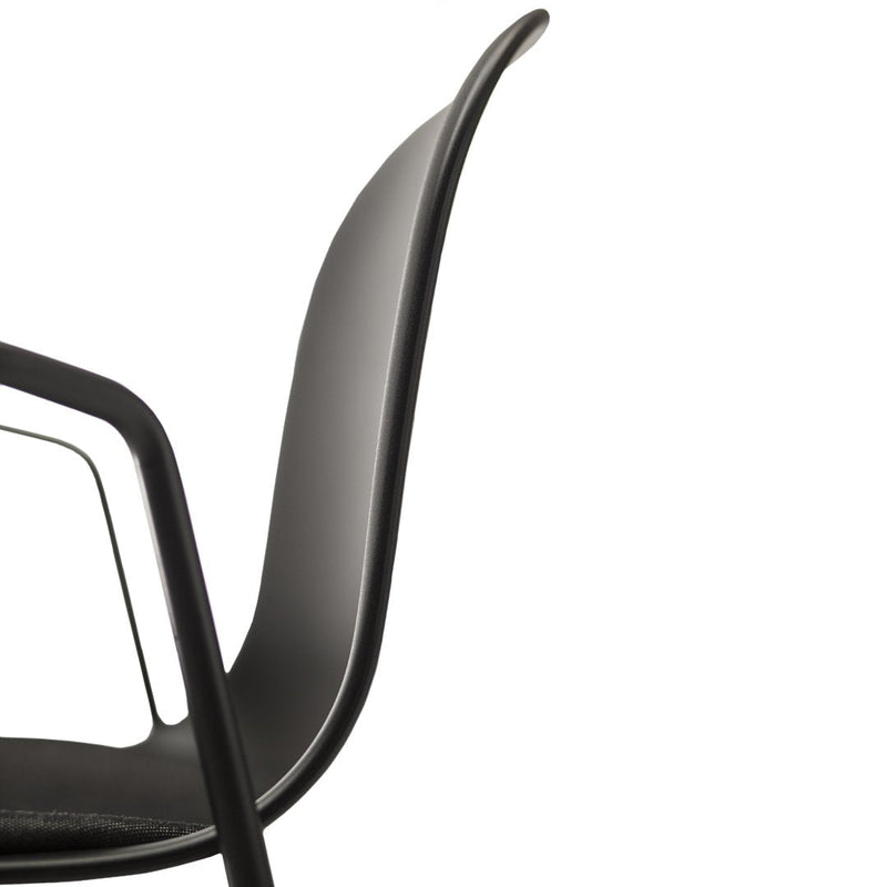 "Elegant black chair with smooth, curved lines and a minimalist design, perfect for modern interiors."