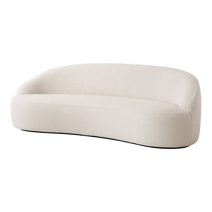 Curved cream sofa with soft texture and minimalist design, perfect for modern decor.