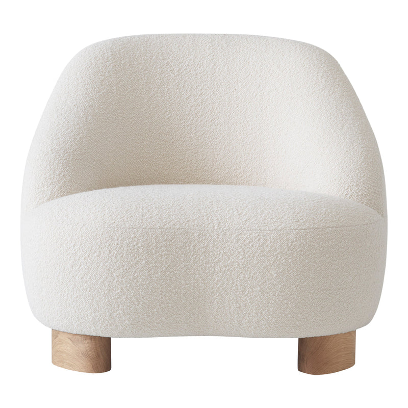 Soft cream lounge chair with a textured, boucle fabric and natural wooden legs. Perfect for modern interiors.