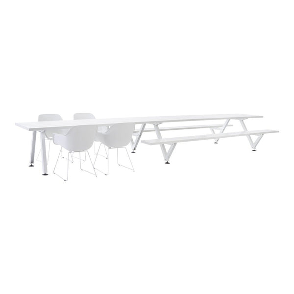 White minimalist dining table with sleek lines and matching white chairs, perfect for modern decor.