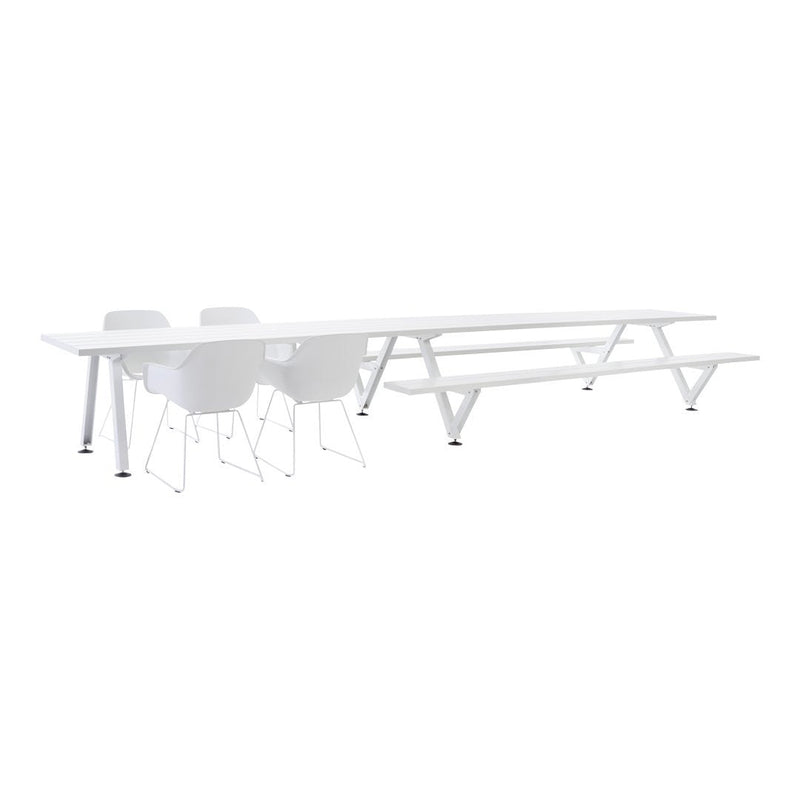 White minimalist dining table with sleek lines and matching white chairs, perfect for modern decor.
