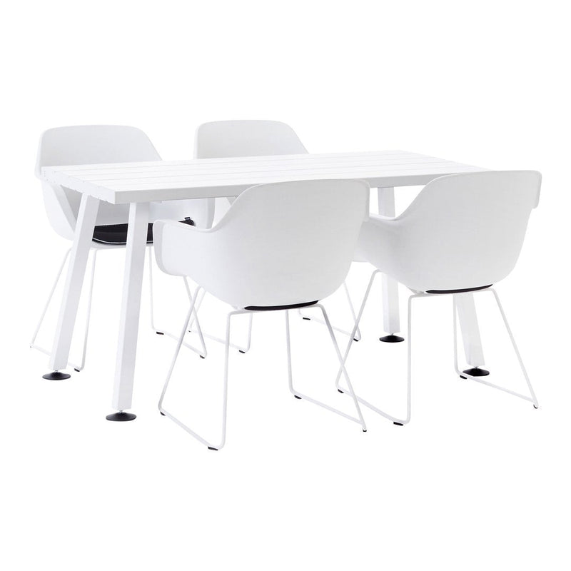 White modern dining table with four matching white chairs featuring black seat cushions. Clean, minimalist design.