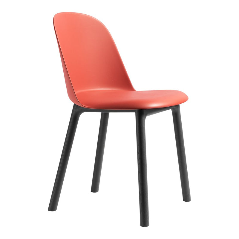 Red chair with a smooth, matte finish and sleek black legs, perfect for modern decor.
