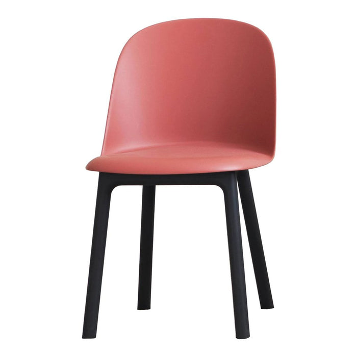 Coral pink chair with smooth plastic seat and black wooden legs, perfect for modern decor.