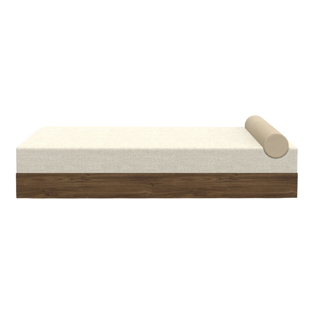 Beige and cream daybed with a smooth, solid wood base and a matching cylindrical cushion. Minimalist design.