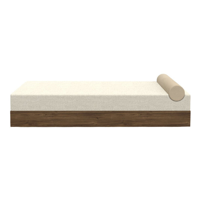 Beige and cream daybed with a smooth, solid wood base and a matching cylindrical cushion. Minimalist design.