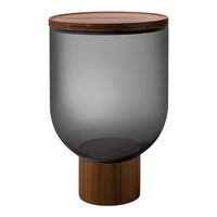 Smoky gray glass table with a natural wood top and a round wooden base, offering a modern and elegant design.
