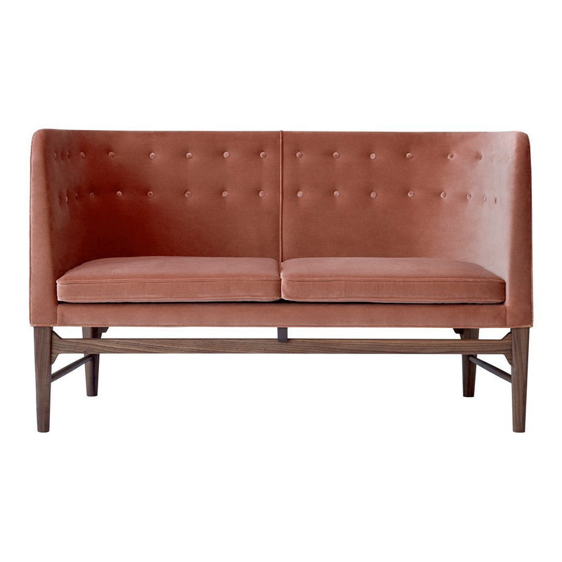Rust-colored upholstered sofa with tufted detailing and a dark wood frame, perfect for modern decor.