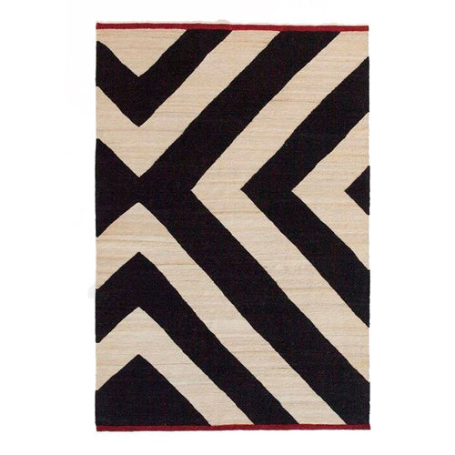 Black and ivory geometric rug with bold zigzag patterns and a red border. Stylish and modern accent for any space.