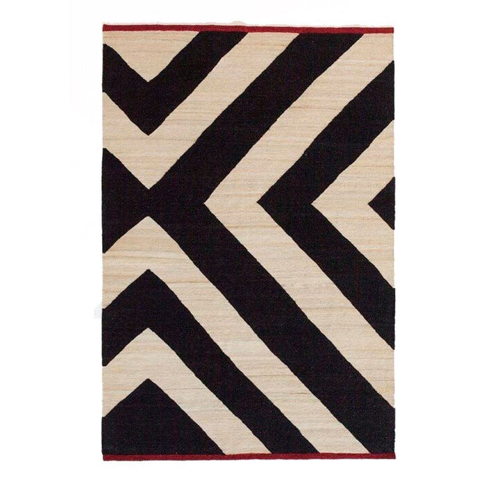 Black and ivory geometric rug with bold zigzag patterns and a red border. Stylish and modern accent for any space.