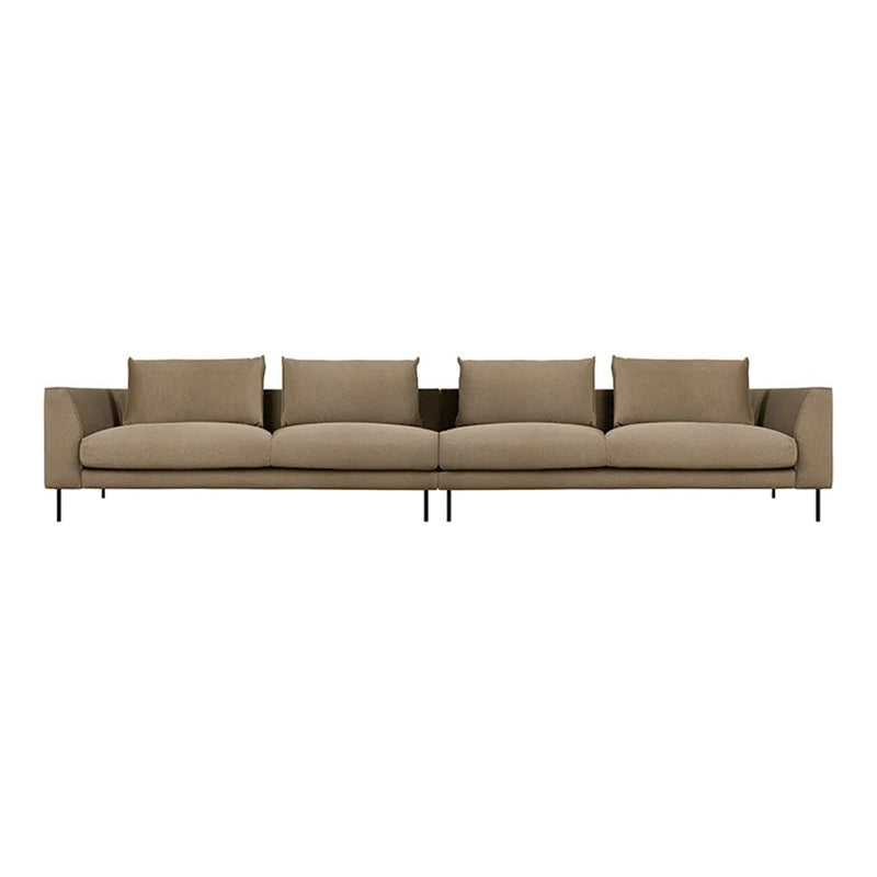 Beige sectional sofa with clean lines, featuring plush cushions and minimalist design on slender black legs.