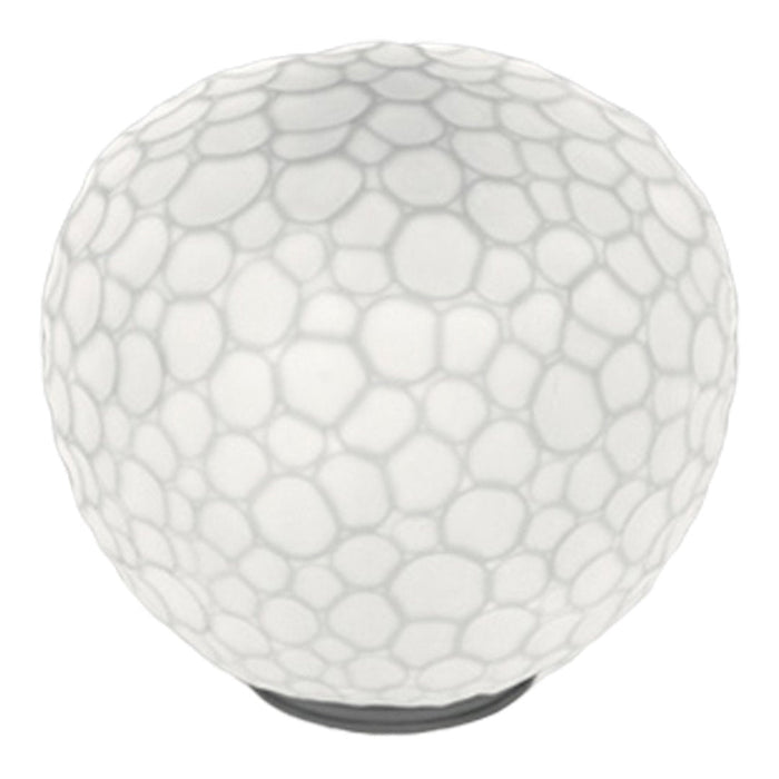 White round lamp with a textured bubble pattern and a sleek black base, ideal for modern decor.