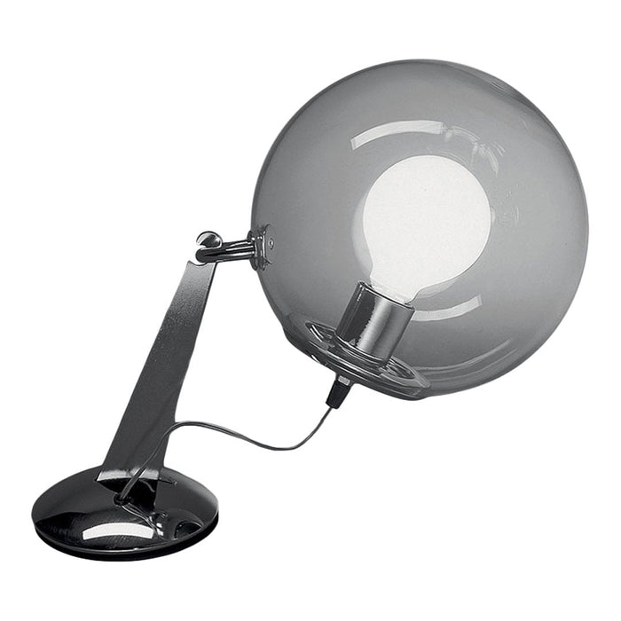 Sleek chrome desk lamp with a clear round glass shade and black base, creating a modern, minimalist aesthetic.