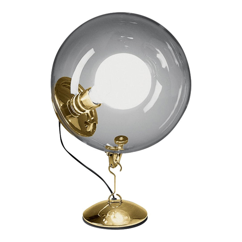 "Gold base and detailing with a large, clear spherical glass shade."
