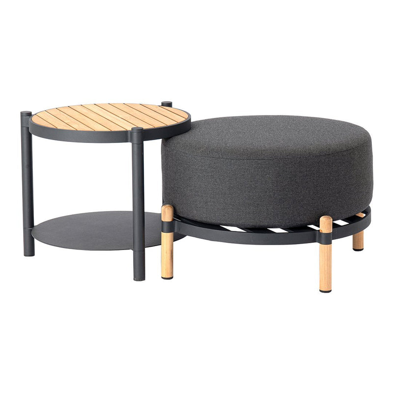 Dark gray upholstered ottoman and wooden side table with natural wood accents and sleek black metal legs.