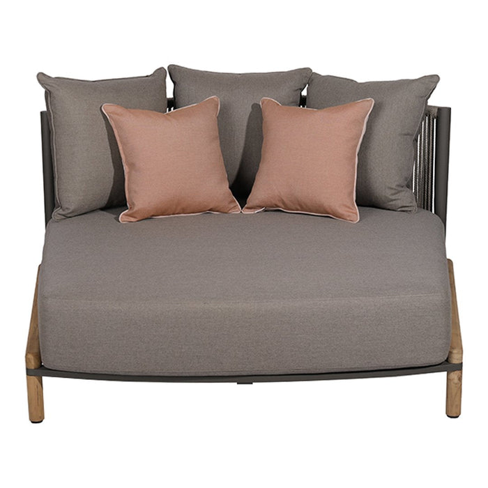 Gray upholstered daybed with pink accent pillows in a modern design. Perfect for stylish outdoor lounging.