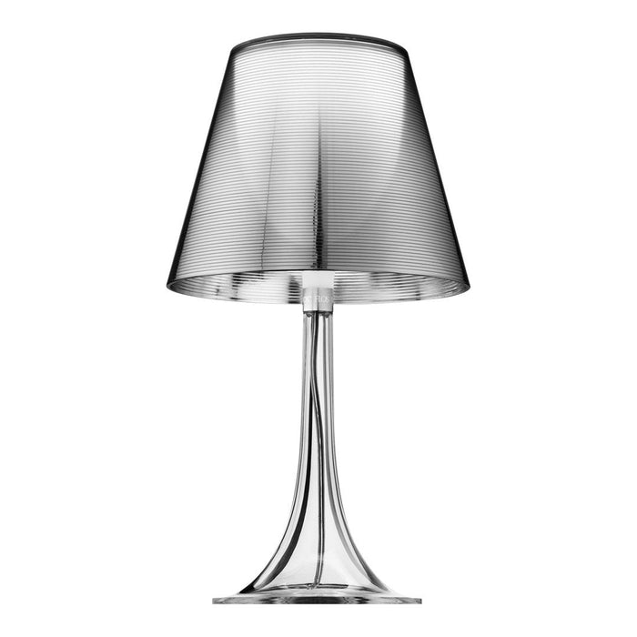 Sleek silver table lamp with a glossy finish and smooth, curved lines. Modern design enhances any decor.