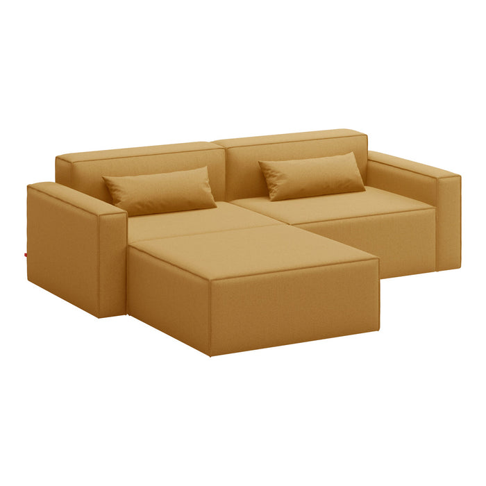 Mustard yellow sectional sofa with clean lines and smooth fabric, featuring matching throw pillows.