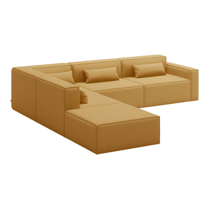Modern L-shaped sofa in warm mustard yellow with smooth, sleek lines and plush cushions for comfort.
