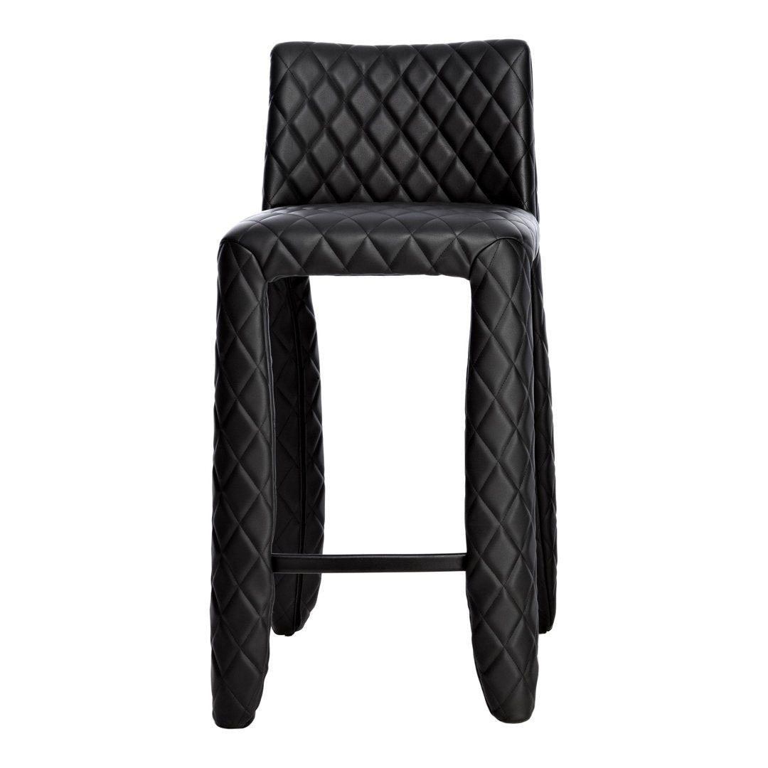 Black bar stool with diamond quilted pattern and smooth finish, perfect for modern decor.