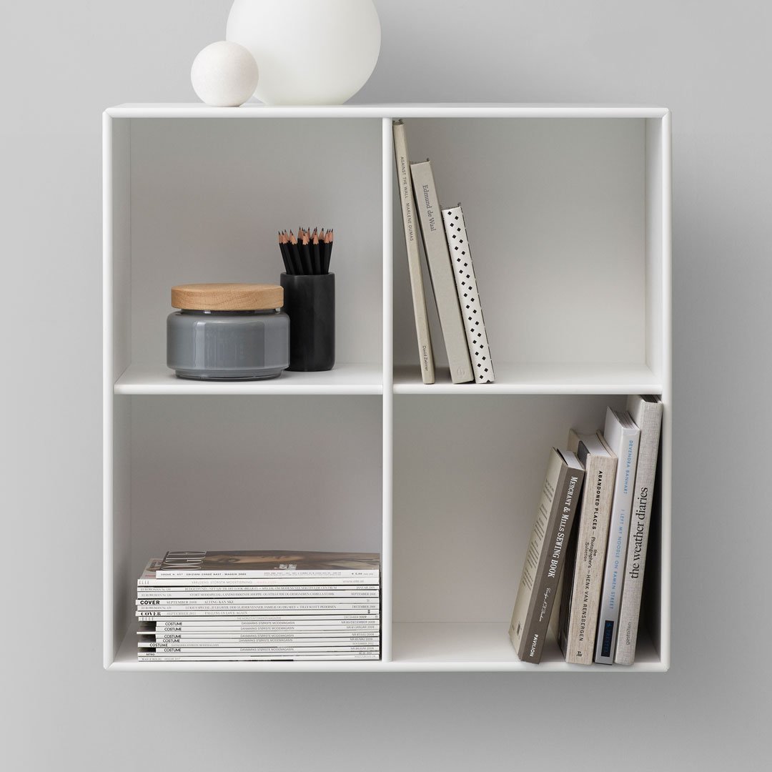 White shelving unit featuring gray accents, wooden lid, and polka dot pattern on a book for a modern, minimalistic look.