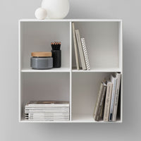 White shelving unit featuring gray accents, wooden lid, and polka dot pattern on a book for a modern, minimalistic look.
