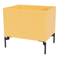 Yellow planter box with a matte finish, set on sleek black metal legs. Modern and minimalist design.