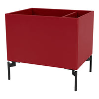 Red planter box on black metal legs, featuring a sleek, modern design with a smooth finish. Perfect for any decor.