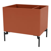 Terracotta planter with a matte finish and sleek black metal legs, featuring a modern, minimalist design.