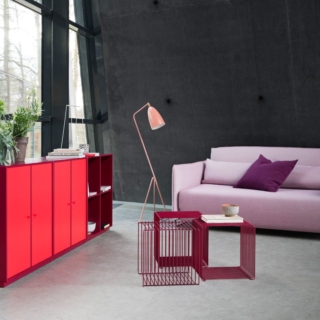 Red and pink furniture with a sleek design, featuring purple accents against a modern gray backdrop.
