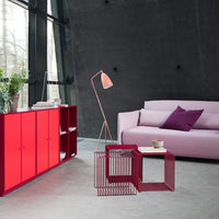 Red and pink furniture with a sleek design, featuring purple accents against a modern gray backdrop.