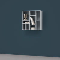 Light gray wall-mounted shelf against a dark blue wall, featuring a sleek, modern geometric design.