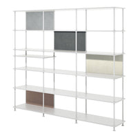 White shelving unit with gray, beige, and brown decorative boxes, featuring a modern geometric pattern.