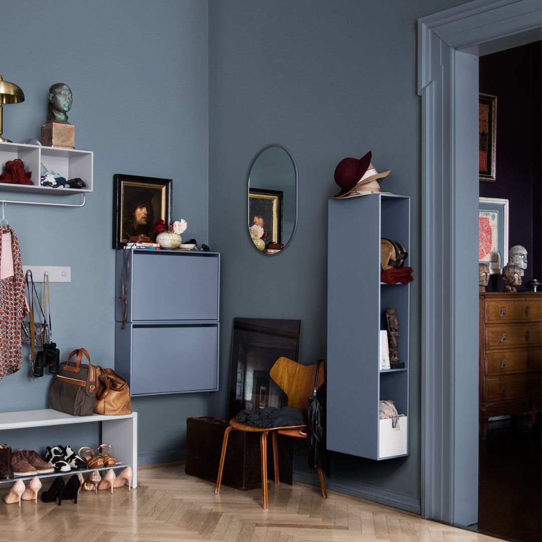 Soft blue walls with gray accents and a mix of textures in a stylish living space. Modern, minimalist patterns enhance decor.