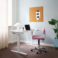Modern workspace featuring a white desk, pink chair, orange bulletin board, and light blue wall accents.
