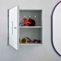 Stylish gray cabinet with vibrant red, yellow, and patterned accessories, showcasing modern design and playful colors.