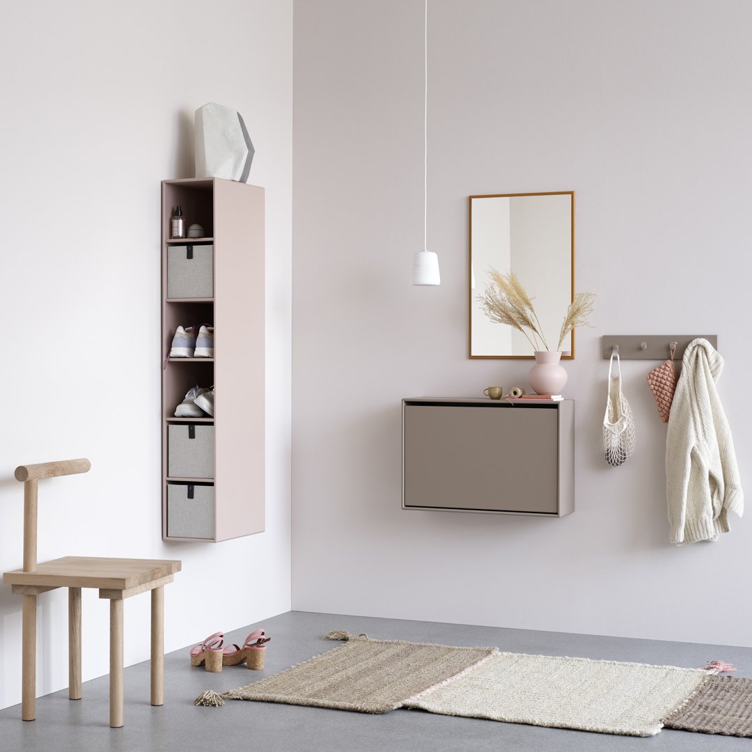 "Modern hallway decor featuring soft pink, gray storage units, and natural textures in a stylish, minimalist design."