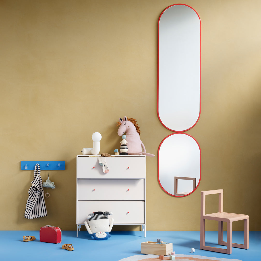 Colorful children's room decor featuring blue flooring, golden walls, and vibrant red accents in mirrors and furniture.