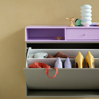 Purple and yellow accent colors on a stylish storage cabinet with contemporary patterns and a neutral background.