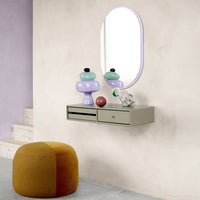 Colorful decor: mint green, lavender, black, and earthy tones on a wall shelf with a round mirror.