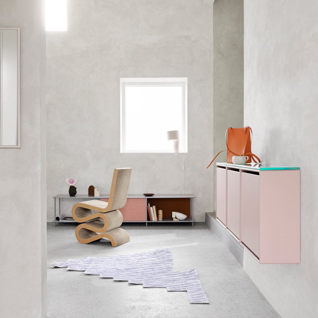Modern room featuring pastel pink, sandy beige, and subtle gray tones with a patterned lilac rug.