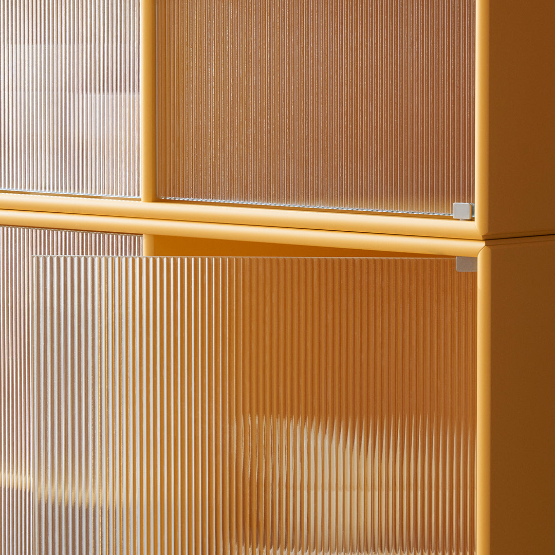 Translucent orange cabinet with vertical ribbed design and a smooth yellow frame, adding a modern touch to any space.