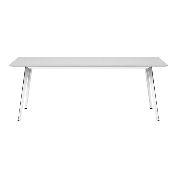 White dining table with sleek metal legs, featuring a minimalist design and smooth surface for modern decor.